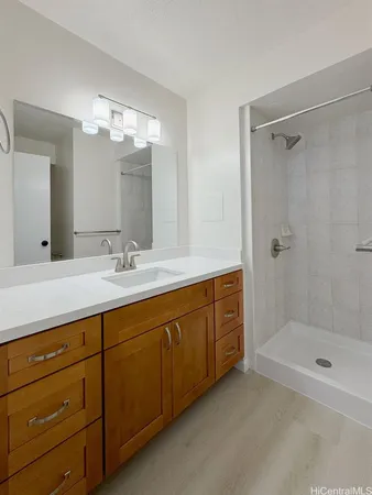 a bathroom with a double vanity sink mirror and shower