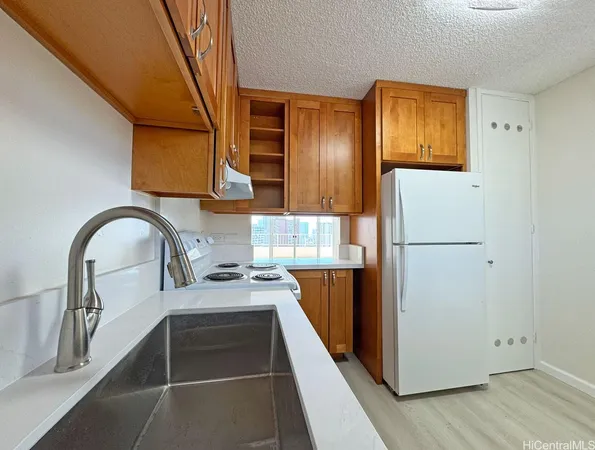 a kitchen with stainless steel appliances a refrigerator and a stove