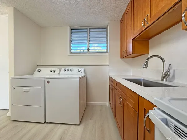 a view of a kitchen with washer and dryer