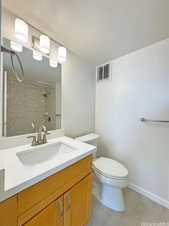 a bathroom with a sink a toilet and a mirror