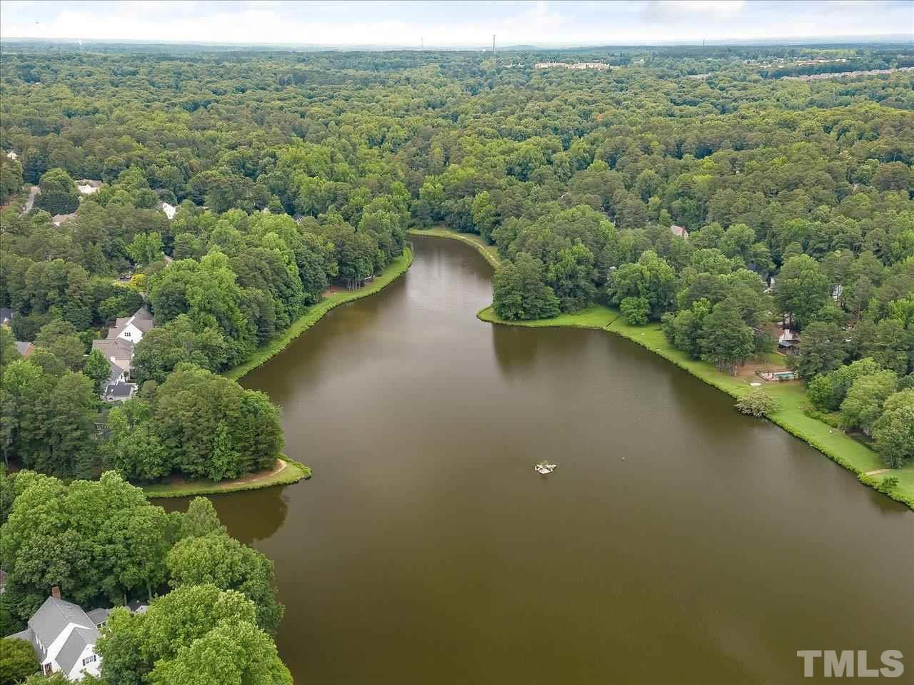 7609 Valley Run Drive Raleigh, NC 27615 - Photo 6 of 30 an aerial view of a houses with a yard and lake