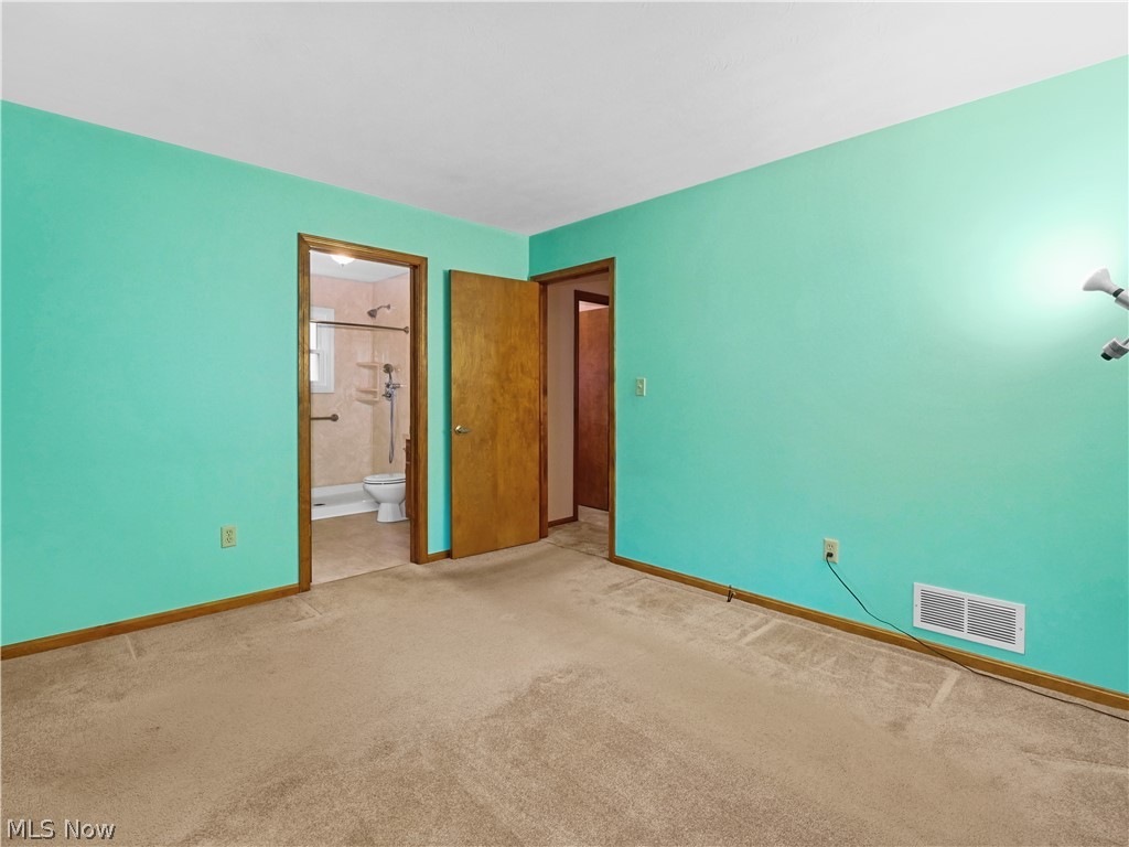 5175 Case Road North Ridgeville, OH 44039 - Photo 15 of 28 Unfurnished bedroom featuring connected bathroom and light colored carpet