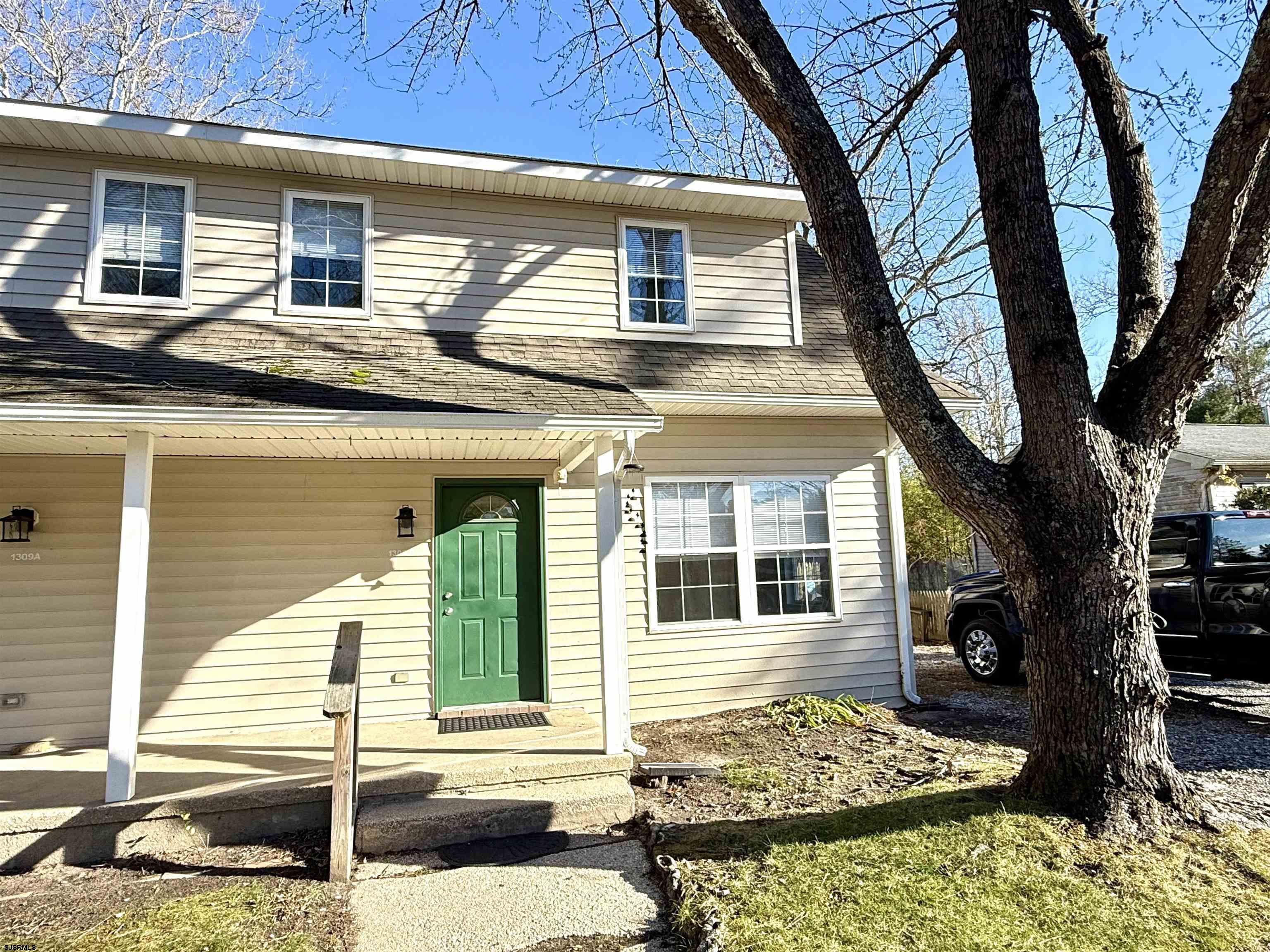 1309 Matthews Avenue, Unit B Mays Landing, NJ 08330 - Photo 1 of 19 a front view of a house with garden