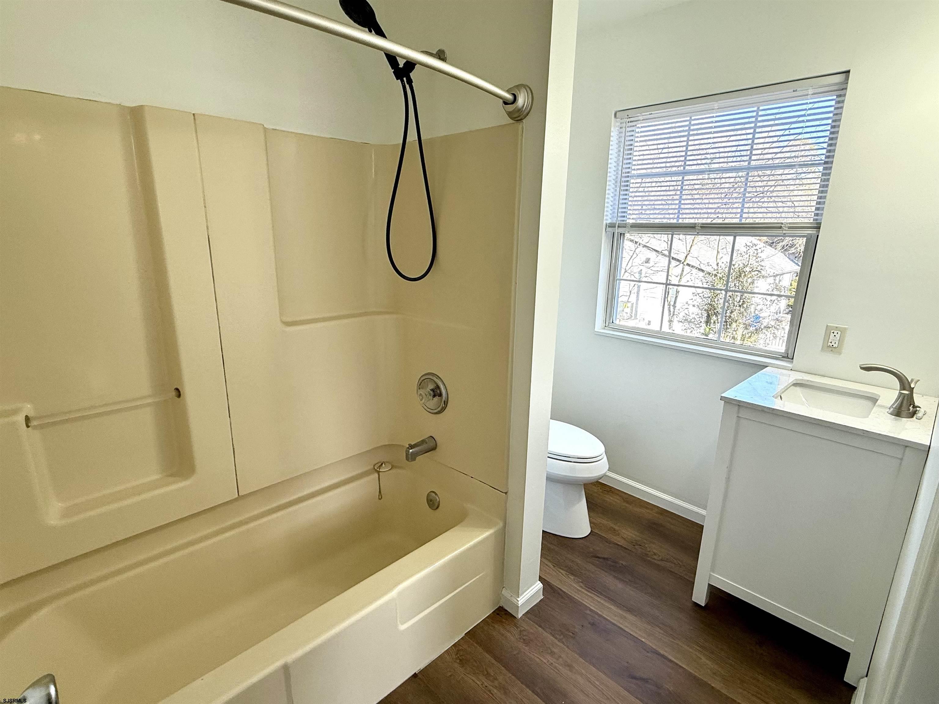 1309 Matthews Avenue, Unit B Mays Landing, NJ 08330 - Photo 14 of 19 a bathroom with a granite countertop sink a toilet and shower