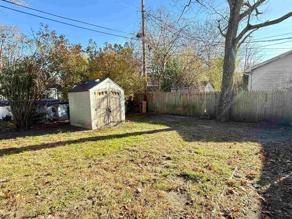 a view of a backyard with large trees