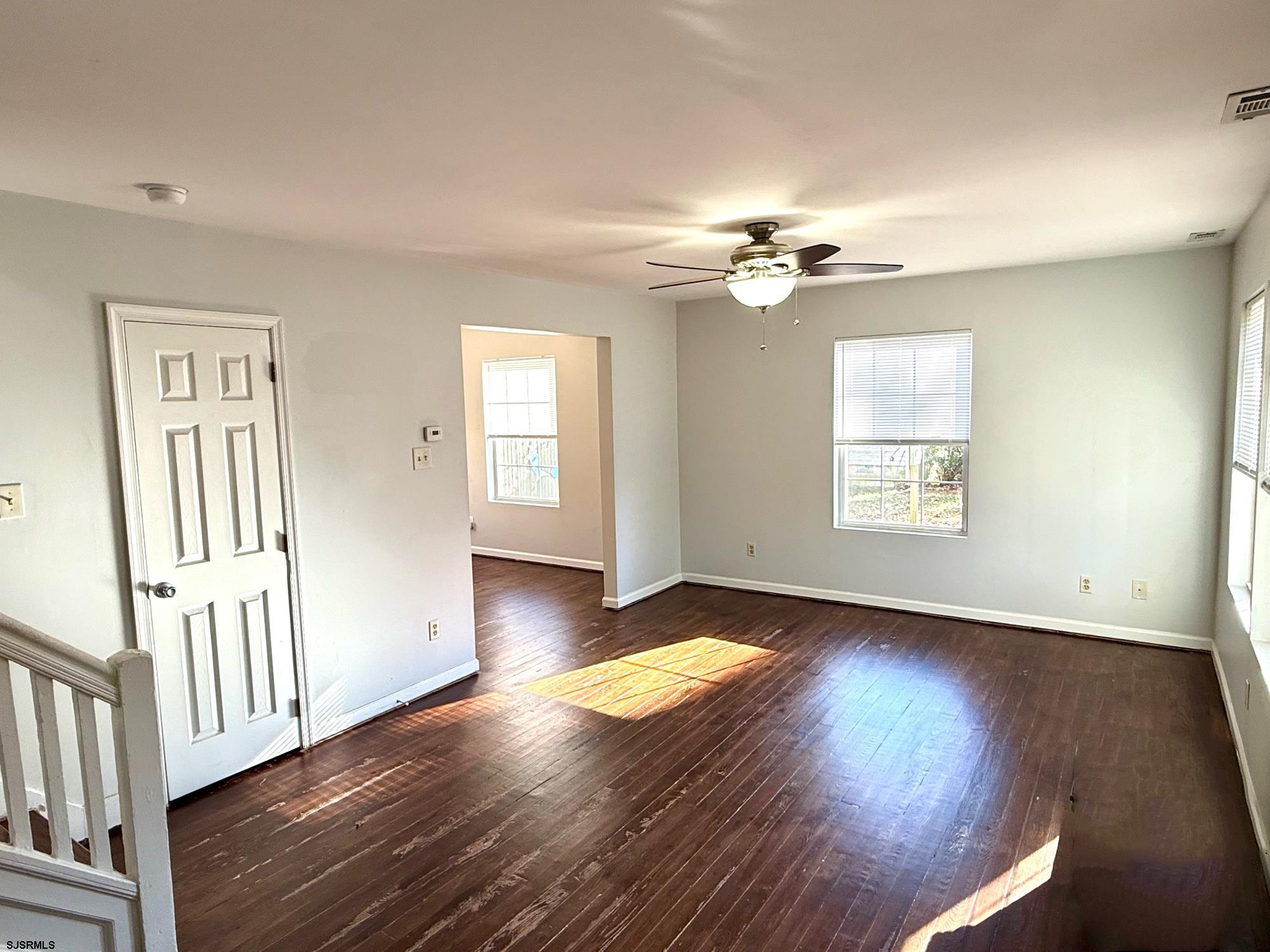 1309 Matthews Avenue, Unit B Mays Landing, NJ 08330 - Photo 4 of 19 wooden floor in an empty room with a window