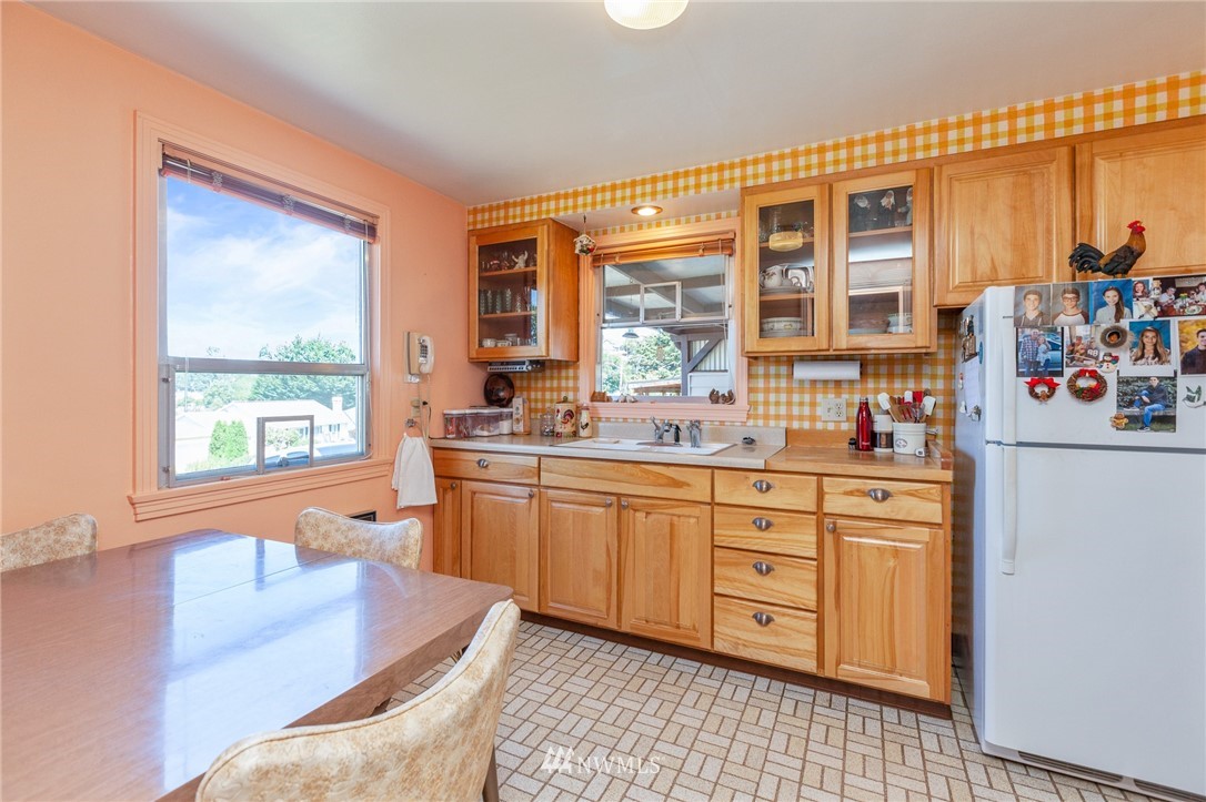 464 Bronson Way Northeast Renton, WA 98056 - Photo 6 of 25 a kitchen with stainless steel appliances granite countertop a stove a sink and a refrigerator
