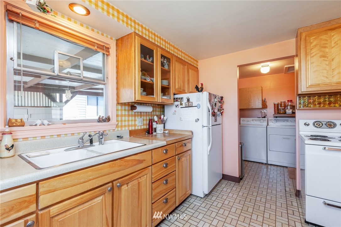 464 Bronson Way Northeast Renton, WA 98056 - Photo 8 of 25 a kitchen with a sink stove and refrigerator