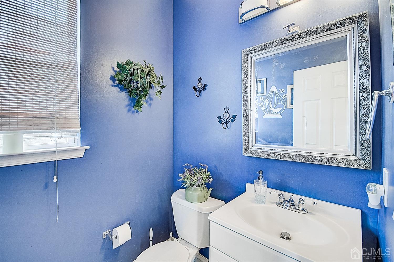 51 Timber Ridge Road North Brunswick, NJ 08902 - Photo 20 of 57 a bathroom with a toilet a sink and mirror