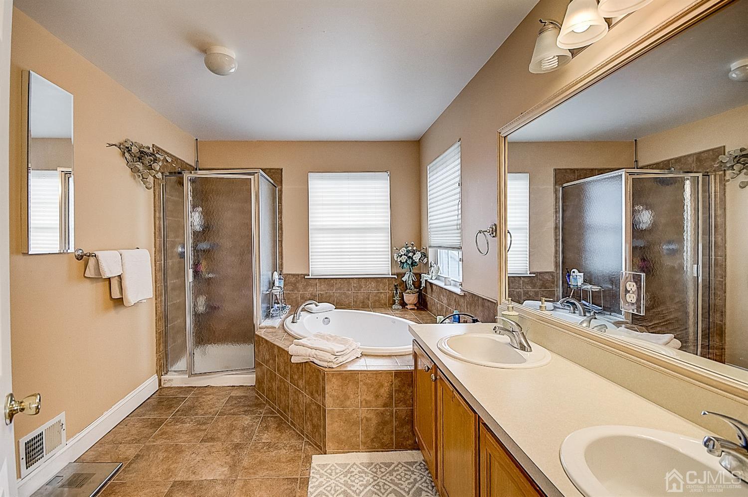 51 Timber Ridge Road North Brunswick, NJ 08902 - Photo 34 of 57 a bathroom with a tub sink and mirror