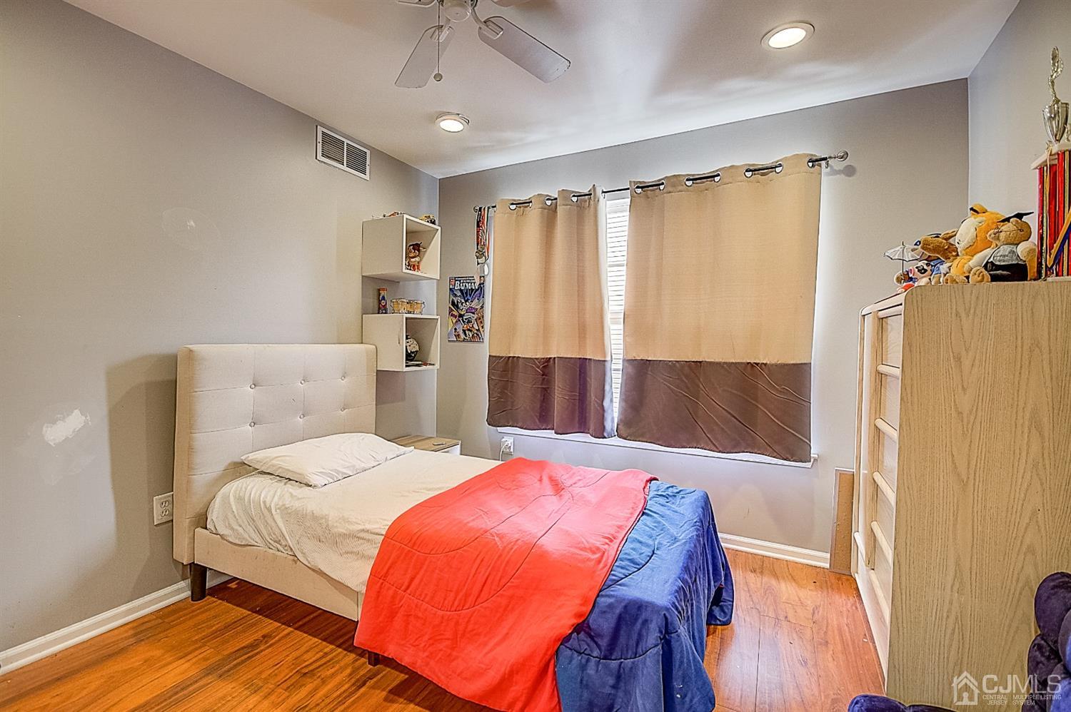 51 Timber Ridge Road North Brunswick, NJ 08902 - Photo 42 of 57 a bedroom with a bed and wooden floor