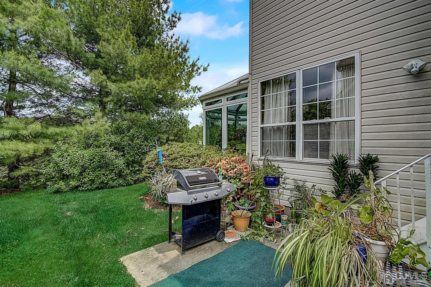 51 Timber Ridge Road North Brunswick, NJ 08902 - Photo 52 of 57 a view of a house with backyard sitting area and garden