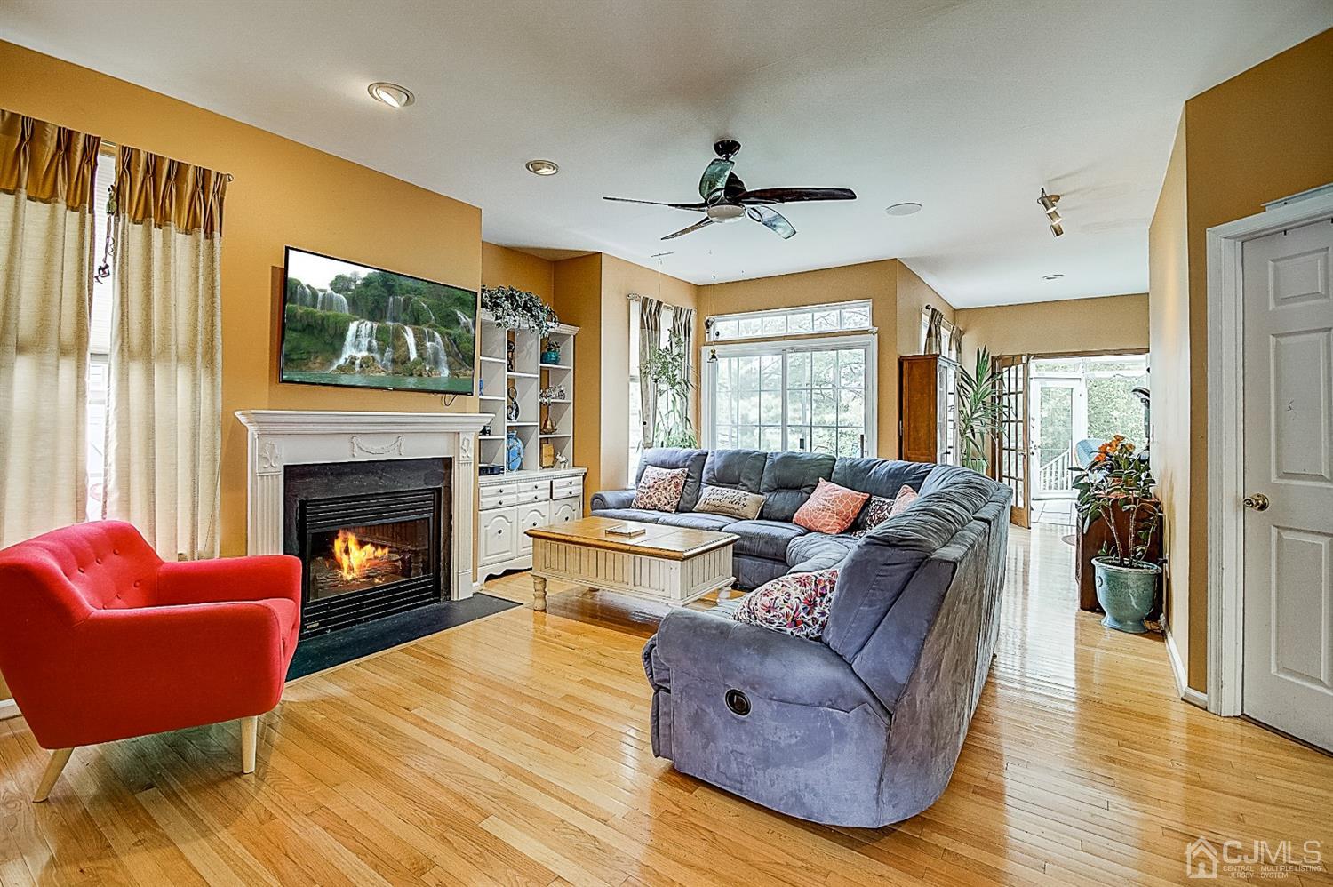 51 Timber Ridge Road North Brunswick, NJ 08902 - Photo 10 of 57 a living room with furniture a fireplace and a large window