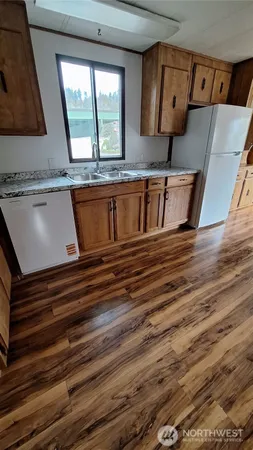 a view of a kitchen with a sink and a window