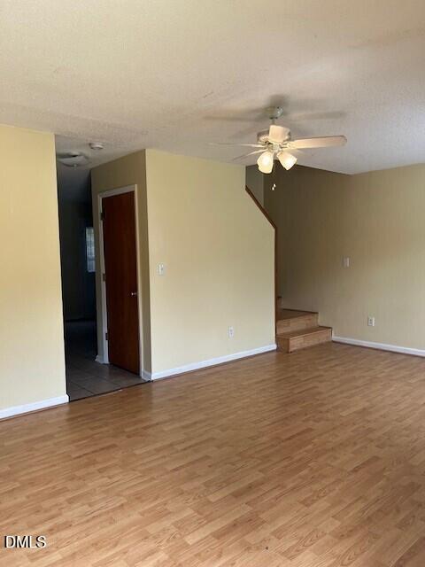 5513 Bringle Court Raleigh, NC 27610 - Photo 2 of 8 a view of a room with wooden floor and ceiling fan