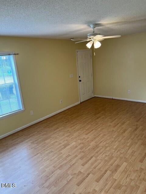 5513 Bringle Court Raleigh, NC 27610 - Photo 4 of 8 a view of a room with wooden floor and fan