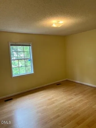 an empty room with a empty space and a window