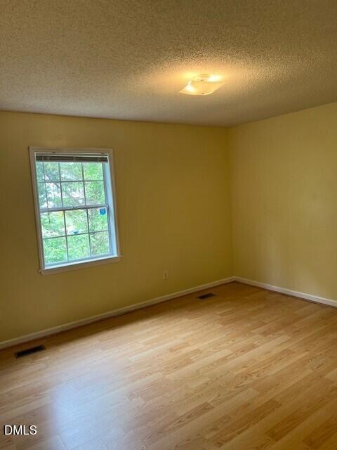 5513 Bringle Court Raleigh, NC 27610 - Photo 6 of 8 an empty room with a empty space and a window