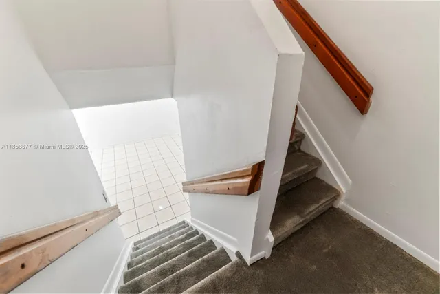 a view of an empty room and staircase