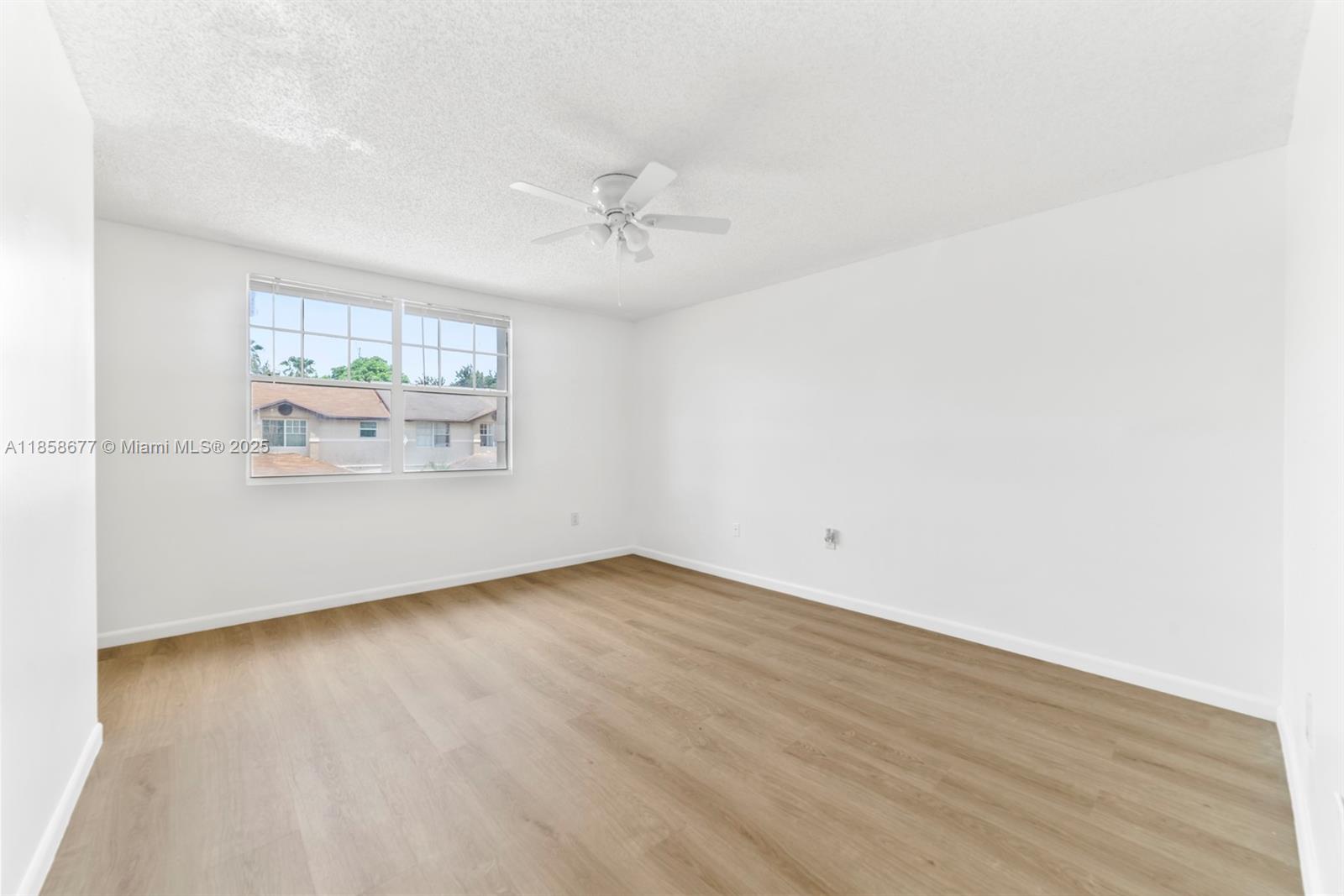 3358 Northwest 198th Terrace Miami Gardens, FL 33056 - Photo 15 of 26 an empty room with wooden floor and windows