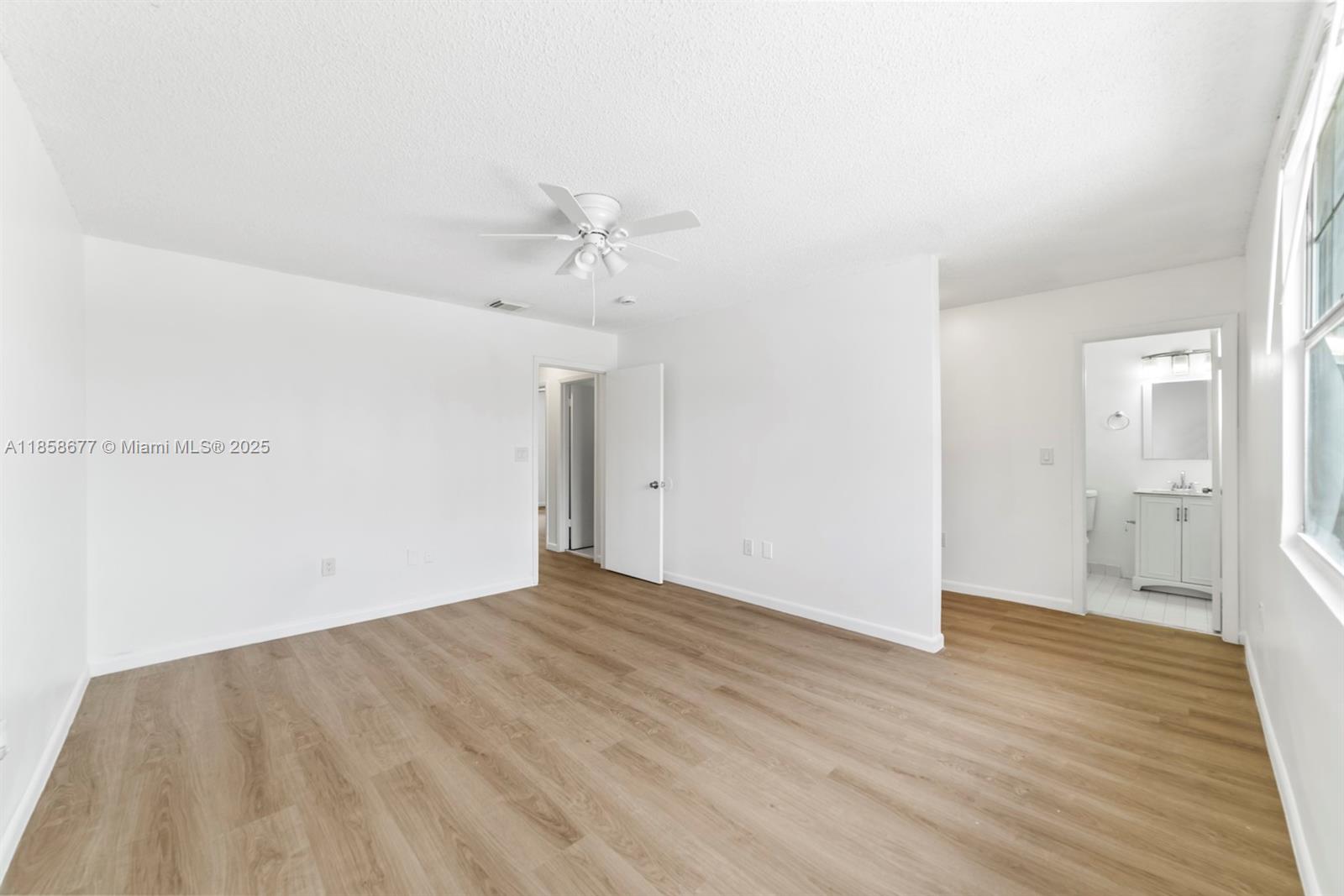 3358 Northwest 198th Terrace Miami Gardens, FL 33056 - Photo 16 of 26 a view of an empty room with wooden floor