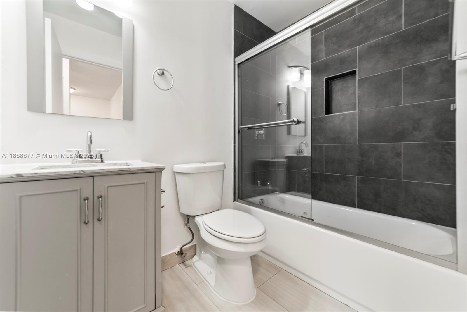 3358 Northwest 198th Terrace Miami Gardens, FL 33056 - Photo 23 of 26 a bathroom with a sink a toilet and shower