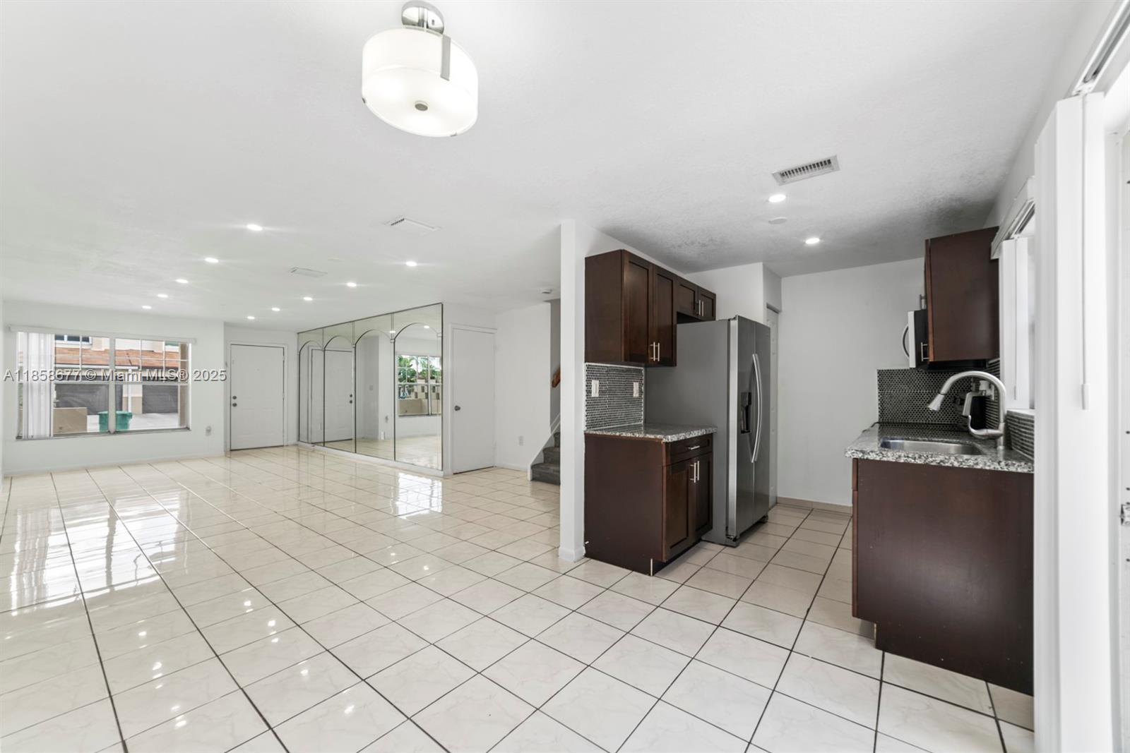 3358 Northwest 198th Terrace Miami Gardens, FL 33056 - Photo 6 of 26 a kitchen with stainless steel appliances granite countertop a refrigerator and a sink