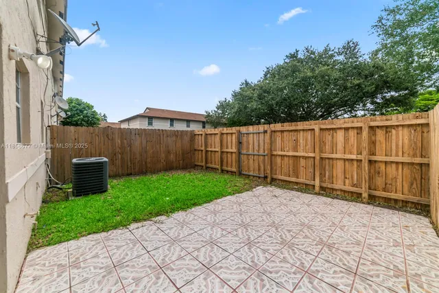 a view of a backyard with wooden fence