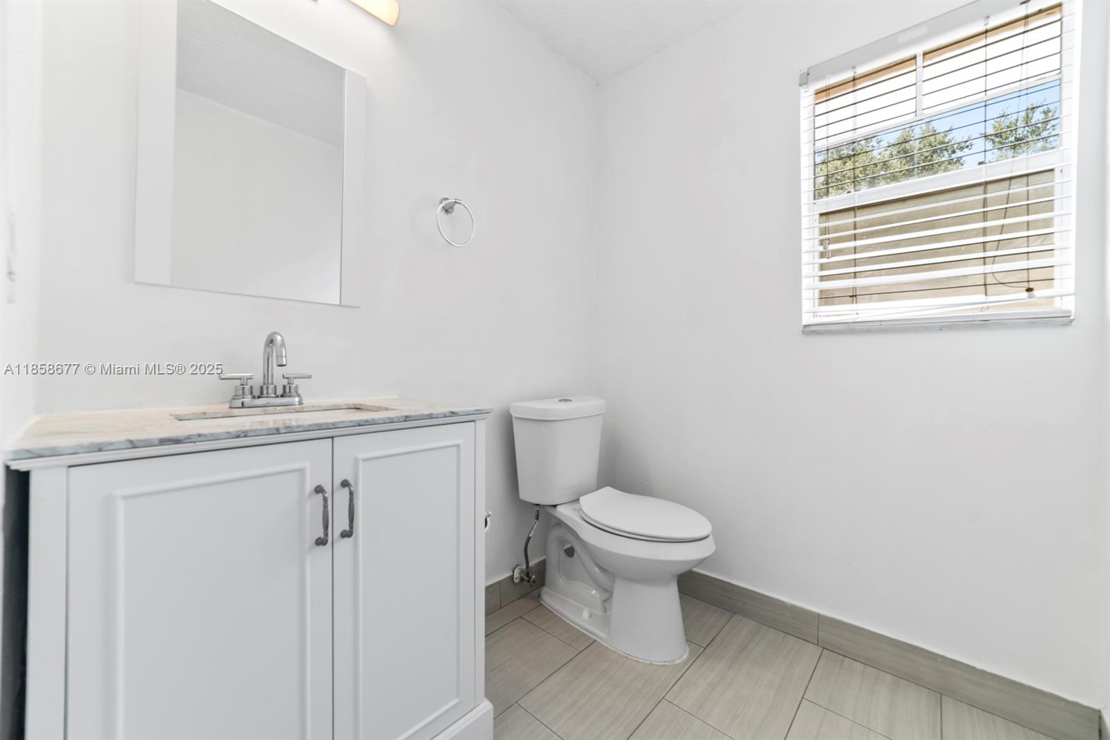 3358 Northwest 198th Terrace Miami Gardens, FL 33056 - Photo 10 of 26 a bathroom with a sink toilet and a mirror
