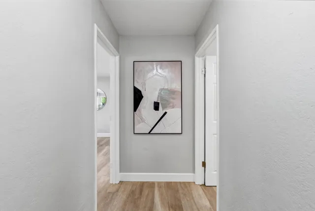 a living room with furniture a fireplace and a large window