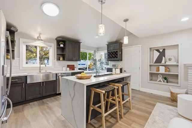 a kitchen with a sink cabinets and window