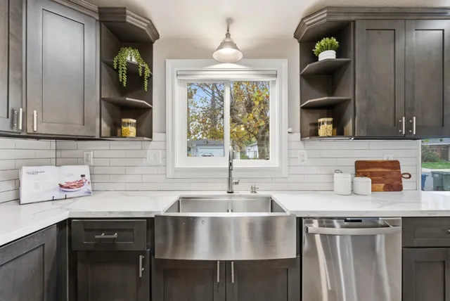 a living room with furniture fireplace and potted plant