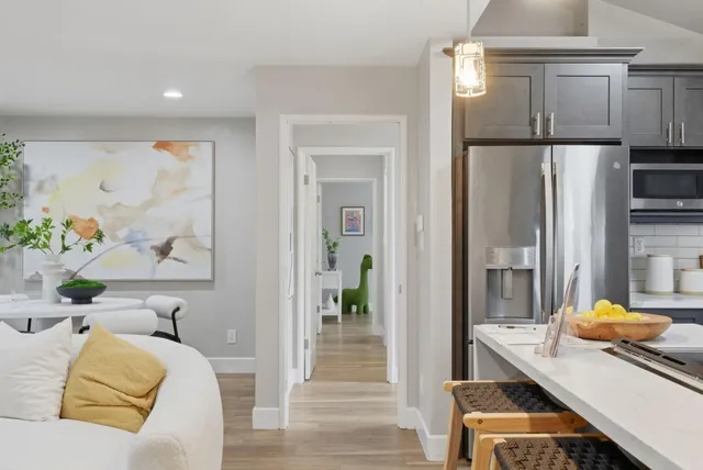 a view of a hallway with wooden floor