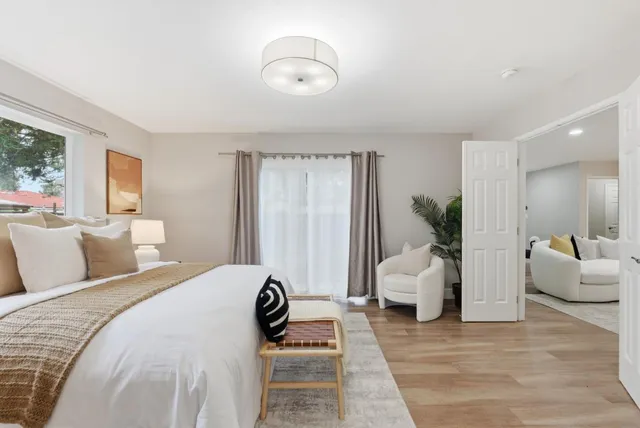 a bedroom with a bed and a window