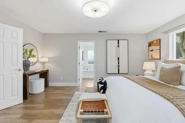 a bedroom with a bed and a table in it