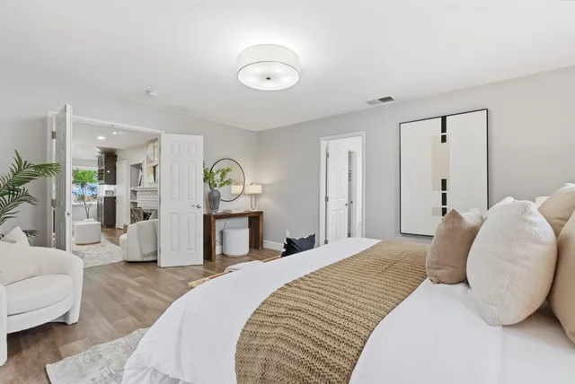 a living room with furniture a window and a clock