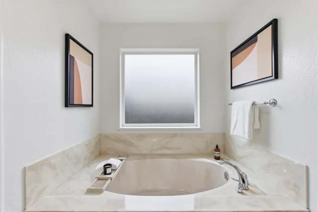 a view of a house with a yard and wooden fence