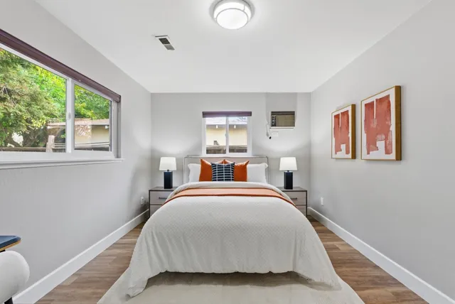 a front view of a house with a tree