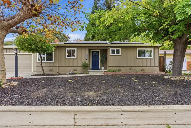 a front view of a house with garden
