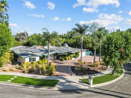 a view of a patio with table and chairs potted plants with wooden fence