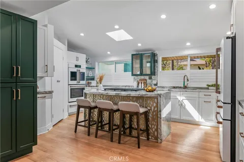 a bathroom with a granite countertop bathtub shower sink vanity and toilet