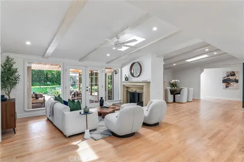 a living room with furniture and a kitchen view
