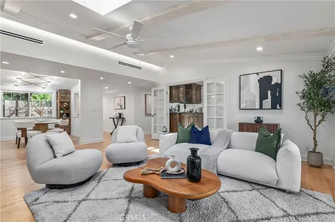 a view of a dining room with furniture wooden floor and chandelier
