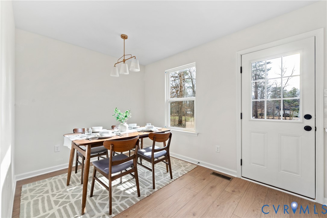 887 Campers Lane Ruther Glen, VA 22546 - Photo 14 of 42 a view of a dining room with furniture window and wooden floor