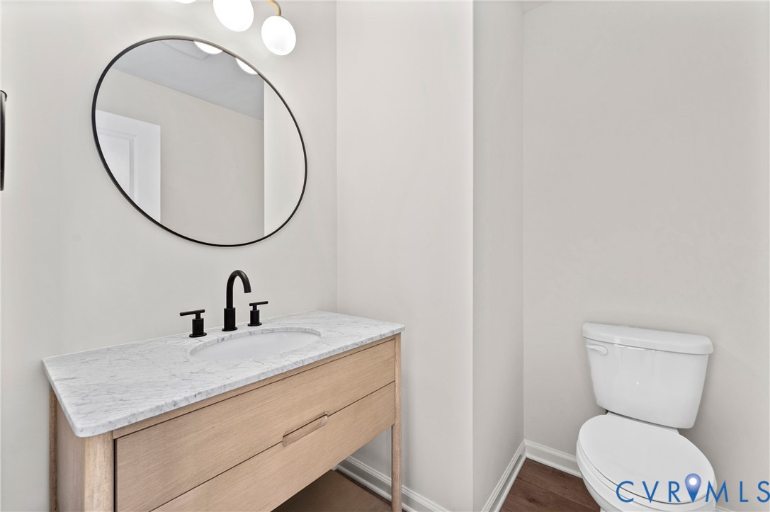 887 Campers Lane Ruther Glen, VA 22546 - Photo 16 of 42 a bathroom with a toilet sink and mirror