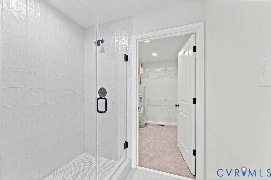 887 Campers Lane Ruther Glen, VA 22546 - Photo 20 of 42 a bathroom with a glass shower door and a sink