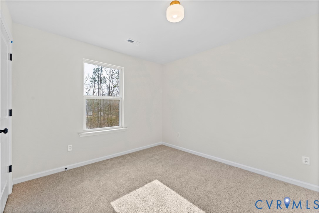 887 Campers Lane Ruther Glen, VA 22546 - Photo 23 of 42 an empty room with windows