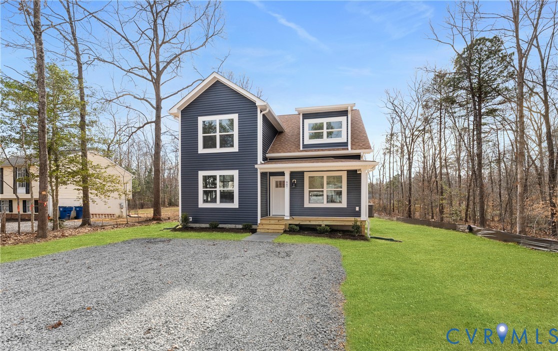 887 Campers Lane Ruther Glen, VA 22546 - Photo 34 of 42 a view of a brick house with a big yard and large trees