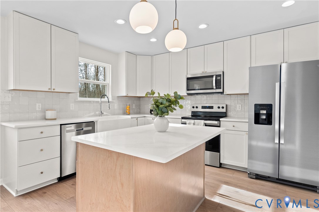 887 Campers Lane Ruther Glen, VA 22546 - Photo 8 of 42 a kitchen with cabinets appliances a sink and a window