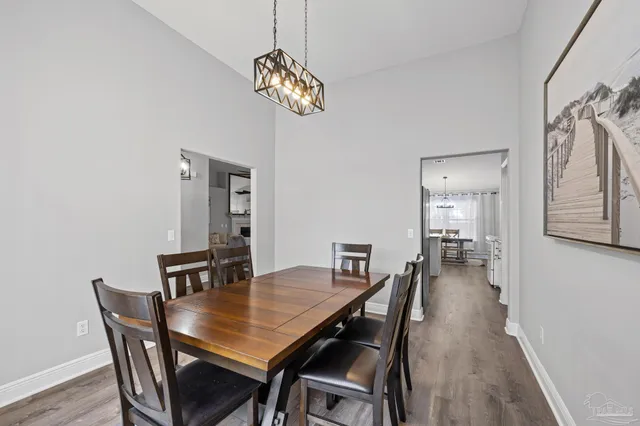 a living room with furniture a fireplace and a chandelier